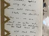 an old book with writing on it sitting on a table