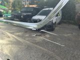 a reflection of a car in a mirror on the side of the road