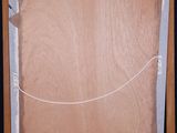 an image of a painting on a easel with a piece of paper taped around it