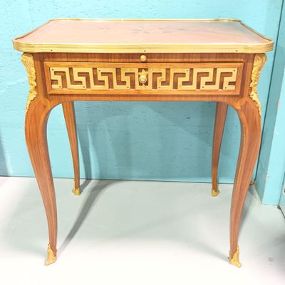 a small wooden table with a drawer on top of it