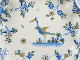 a blue and white plate with a bird on it