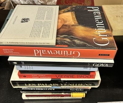 many books stacked on top of each other on a table