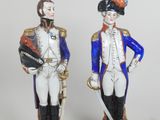 two figurines of two men dressed in military uniforms