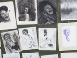 many drawings of people on the wall of a room
