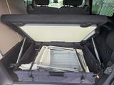 the back of a car with the trunk open and the seats folded down