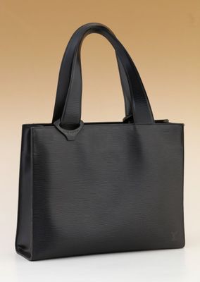 a black handbag on a white surface