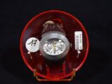 a watch in a red case on a black background