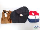 three jackets are lined up on a white surface with a price tag on them
