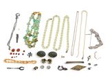 many different types of jewelry on display on a white surface