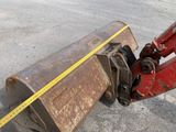 a close up of a red bulldozer with a measuring tape on it