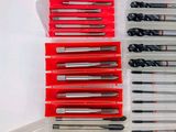 many different types of pens and pencils in a plastic container