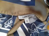 a picture of a lancel shirt with a label on it