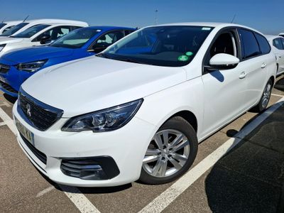 the white car is parked in the parking lot next to other cars