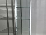 a glass display case in the corner of a room