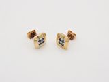 a pair of gold and black diamond earrings on a white background
