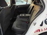 a white car with the door open in a parking lot