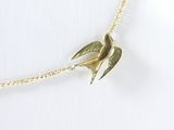 gold plated necklace with a bird pendant on a gold chain
