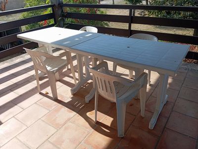 a white table and chairs on the balcony of a house