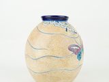 a vase that has a fish design on it