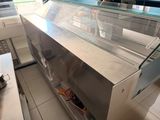 a counter with a glass display case in the middle of it
