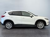 the white mazda cx - hr suv is parked in a parking lot