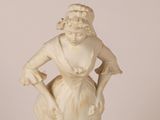 statue of a woman with a basket of flowers in her hand