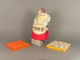 a dress on a mannequin and a book on a table