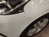 a close up of a white car with a black seat on it