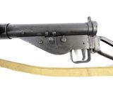 an old machine gun with a sling attached to it ' s side