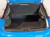the back of a blue car with its trunk open and the seat down