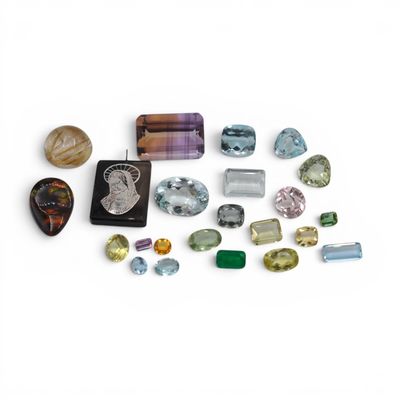 a group of different colored stones and gems on a white surface