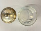a small glass jar with a lid on a white table