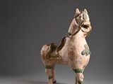 statue of a horse and a fish on a gray surface