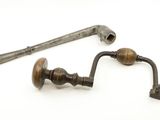 two old tools that are sitting on a white surface