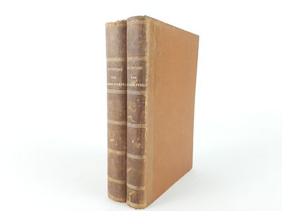 an old book sitting on top of a white surface