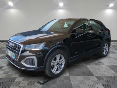 a black audi qx parked on a checkered tile floor