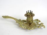 a gold candle holder with a crown on top of it