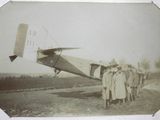 an old photo of a group of people standing in front of an airplane