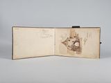 an open book with a drawing of a castle on it