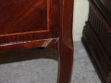 a wooden cabinet with a clock on top of it