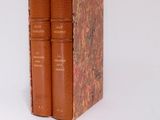 two books sitting on top of each other on a white surface