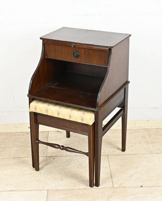 a small wooden desk with a drawer on top of it