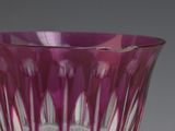 a purple vase that is sitting on a table