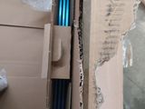 a cardboard box with a pair of blue pens in it