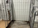 several cages are lined up and ready to be put into a room