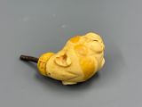 yellow figurine of a man with a pipe sticking out of it ' s mouth