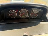 a close up of a car dashboard with gauges and speedometers