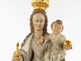 an image of a statue of a woman holding a child and a candle