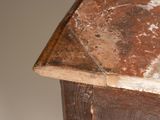 a small wooden table with a marble top on it