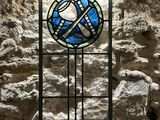 a stained glass window in the middle of a stone wall